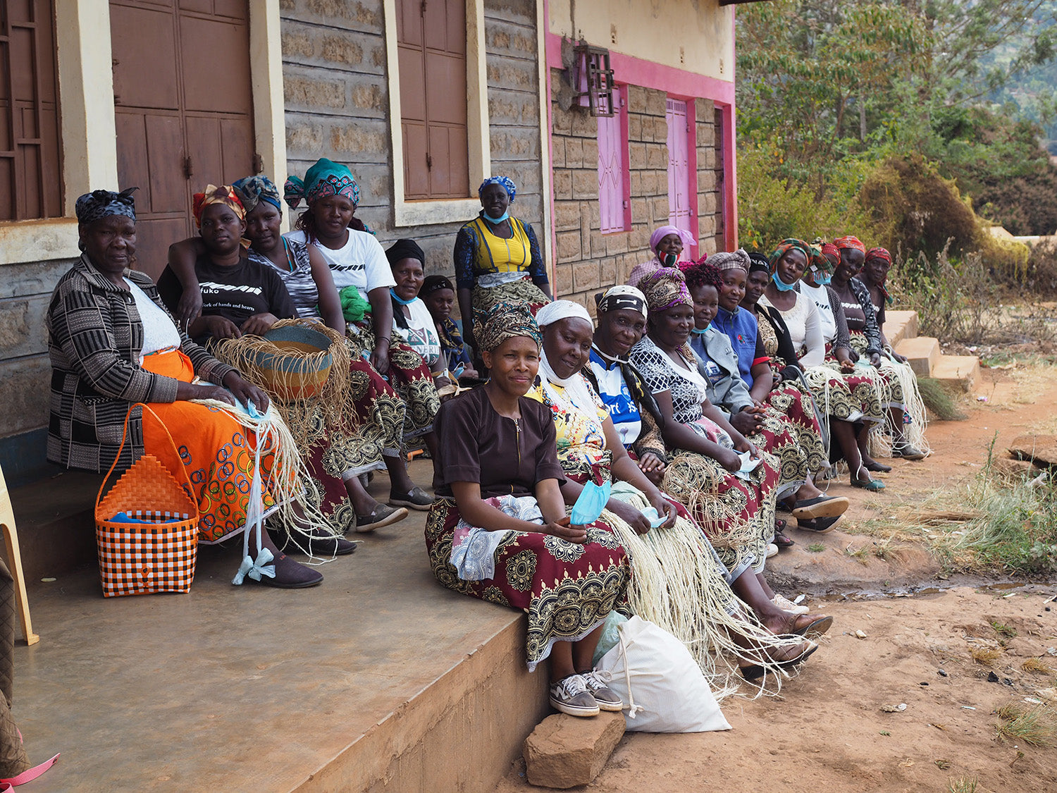 Women sitting in front of a building looking to the same direction