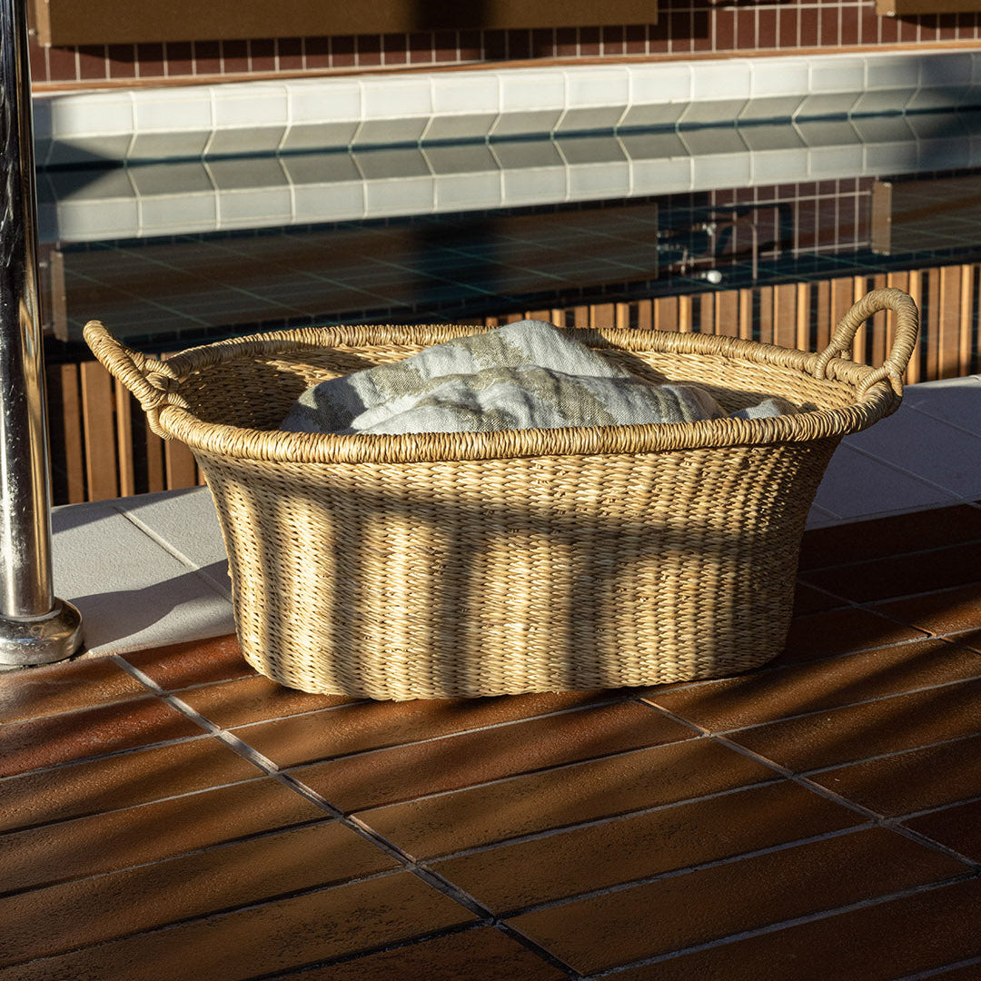 Wicker basket with stones on a tiled floor