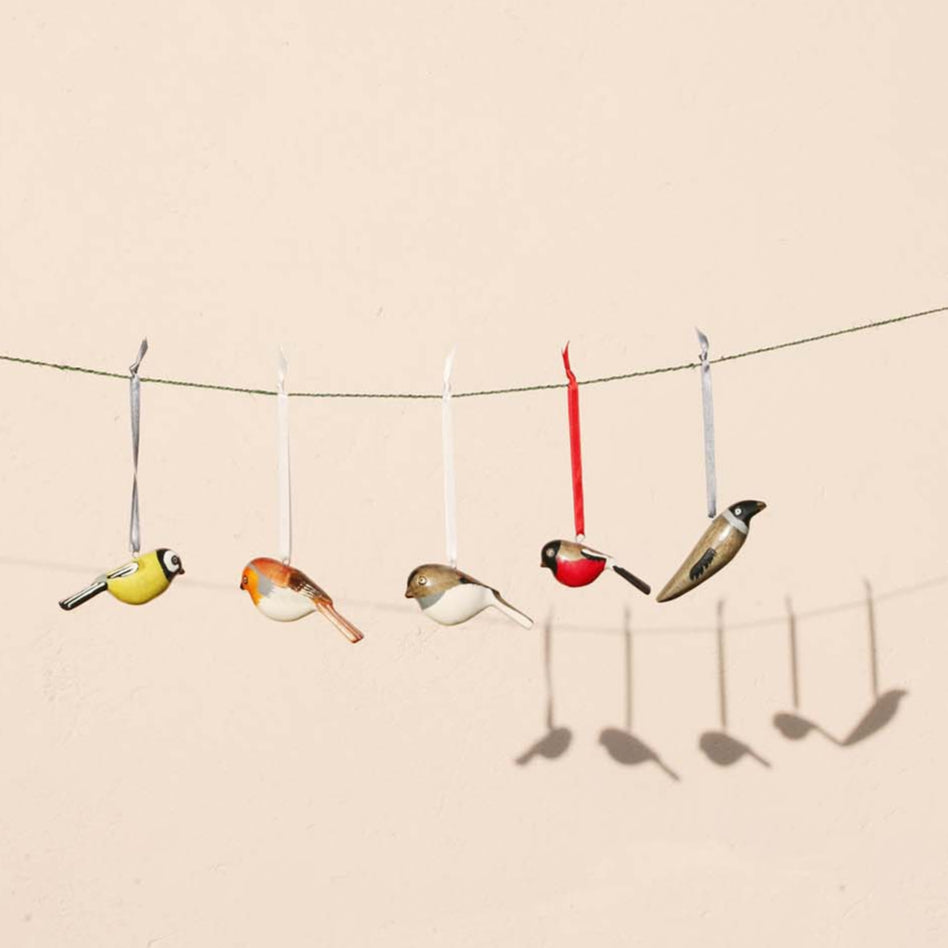 robin charming ornaments are handmade from fallen jacaranda tree branches