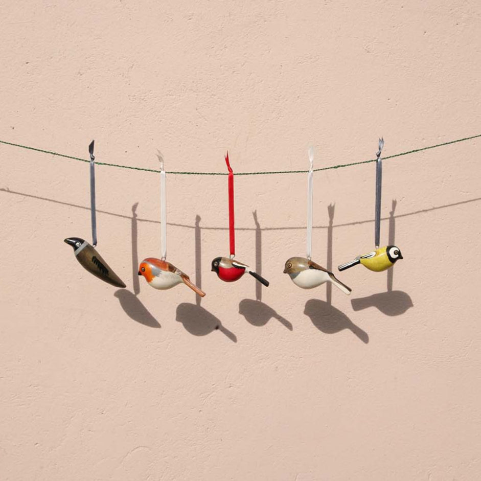 robin charming ornaments are handmade from fallen jacaranda tree branches