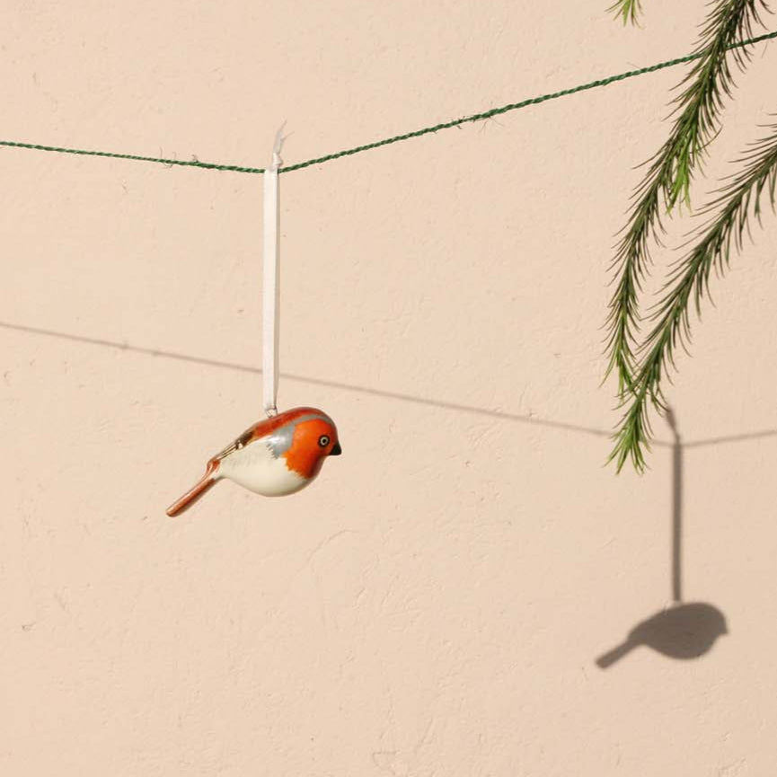 robin charming ornaments are handmade from fallen jacaranda tree branches