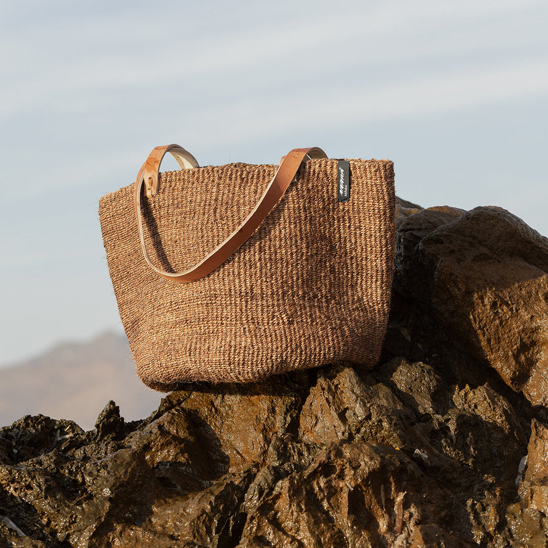 dark brown sisal shoulder bag on rock handmade