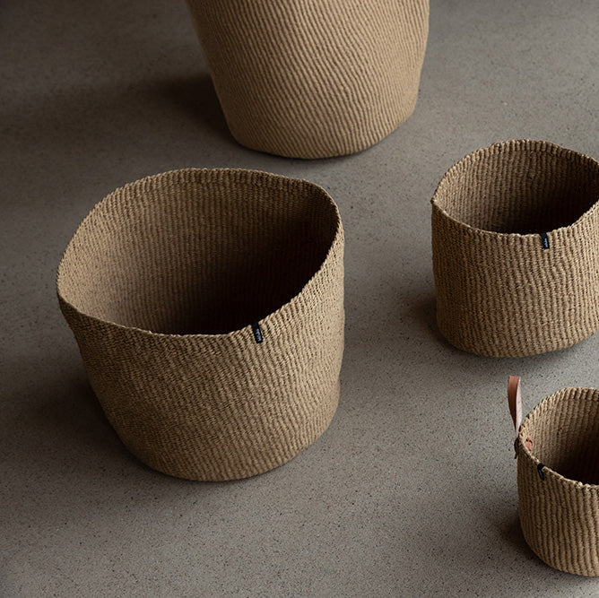 Set of woven baskets of various sizes on a gray background