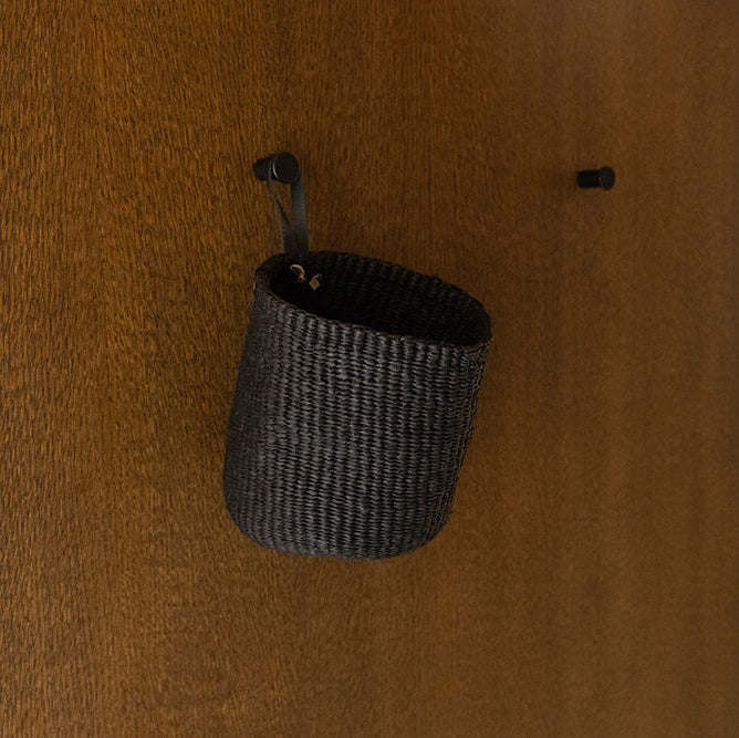 Woven basket hanging on a wooden wall