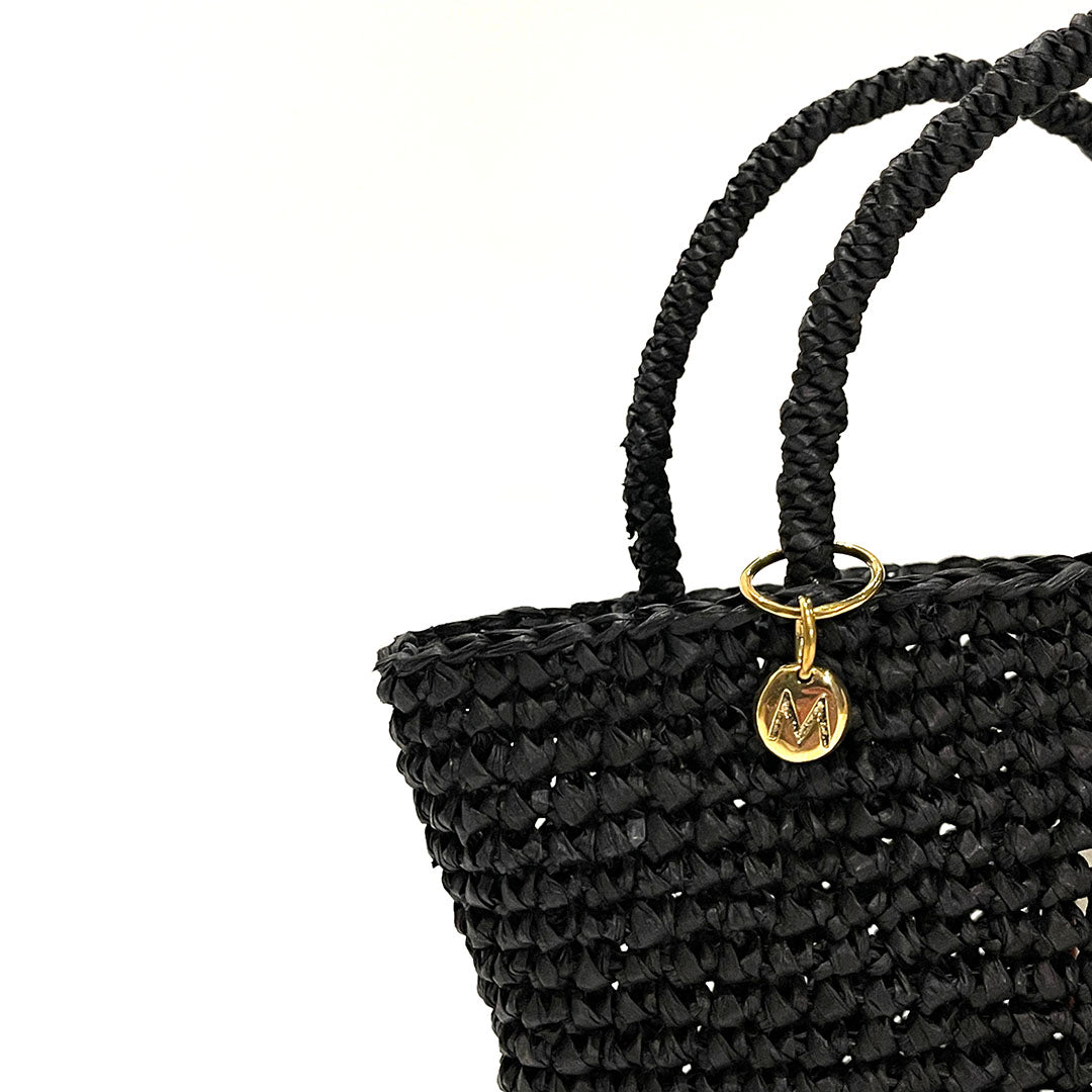 Black handmade crocheted handbag on a white background