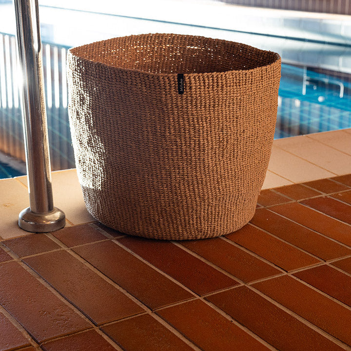 Beautiful handmade brown basket by the pool