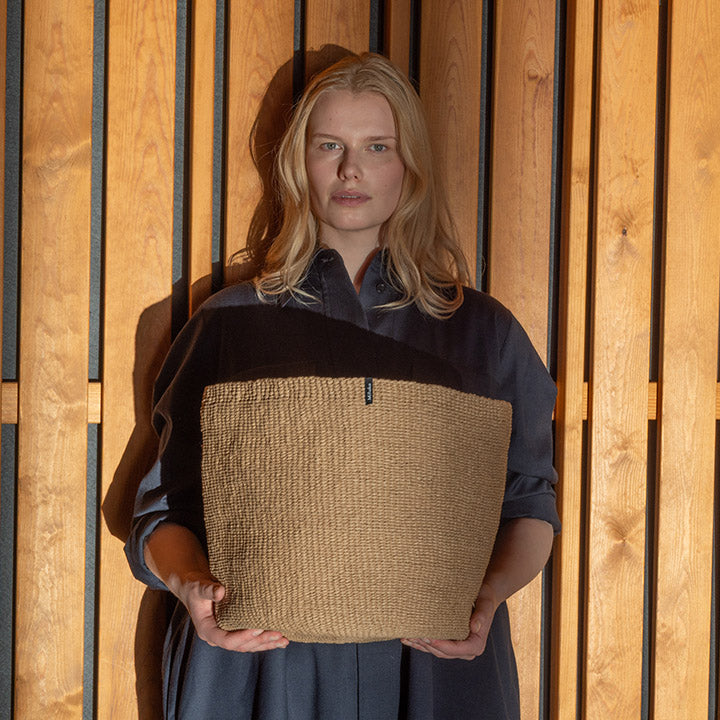 woman holding handmade basket in a beautiful light