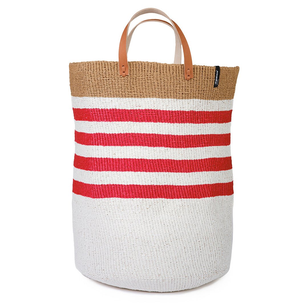 The Kiondo floor basket with elegant thin red stripes is a versatile and stylish storage solution for your home. Handwoven with care by skilled artisans, this extra-large basket is made from FSC-certified paper and upcycled plastic, combining lightweight durability with a commitment to sustainability.