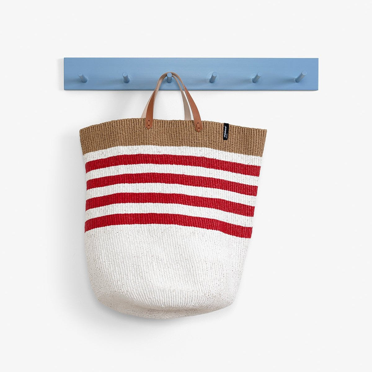 The Kiondo floor basket with elegant thin red stripes is a versatile and stylish storage solution for your home. Handwoven with care by skilled artisans, this extra-large basket is made from FSC-certified paper and upcycled plastic, combining lightweight durability with a commitment to sustainability.