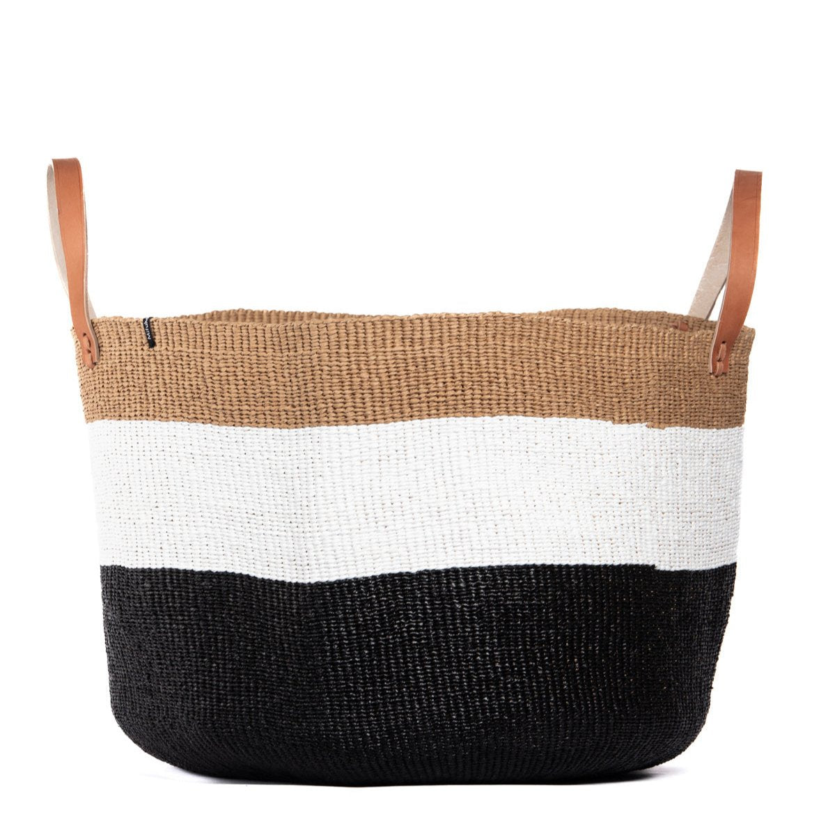 The Kiondo floor basket in Duo Black is a stunning and functional storage solution that seamlessly blends traditional craftsmanship with modern design. Handwoven by skilled artisans, this extra-large basket is crafted from a durable mix of FSC-certified paper and recycled plastic, ensuring it is lightweight, strong, and environmentally friendly.