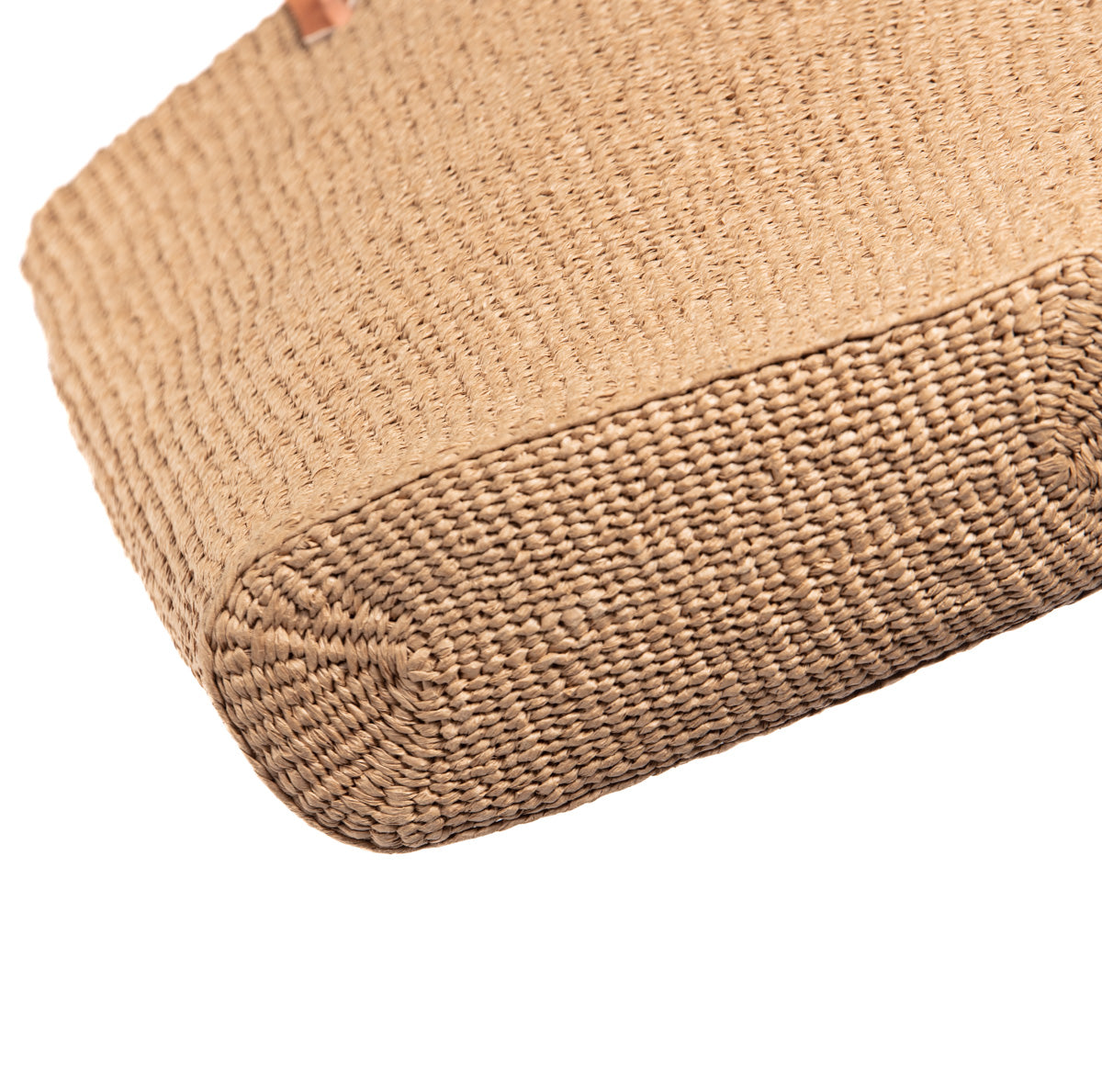 Close-up of a woven brown bag bottom on a white background