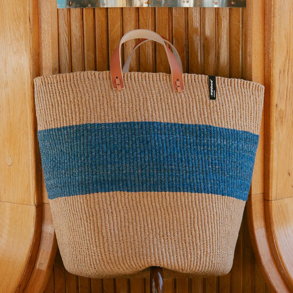 The Majani Market Basket is a stylish and durable handwoven basket made from natural banana fibre. With its subtle denim blue tone, it is the perfect addition to your home for shopping, storage, or decorative purposes.