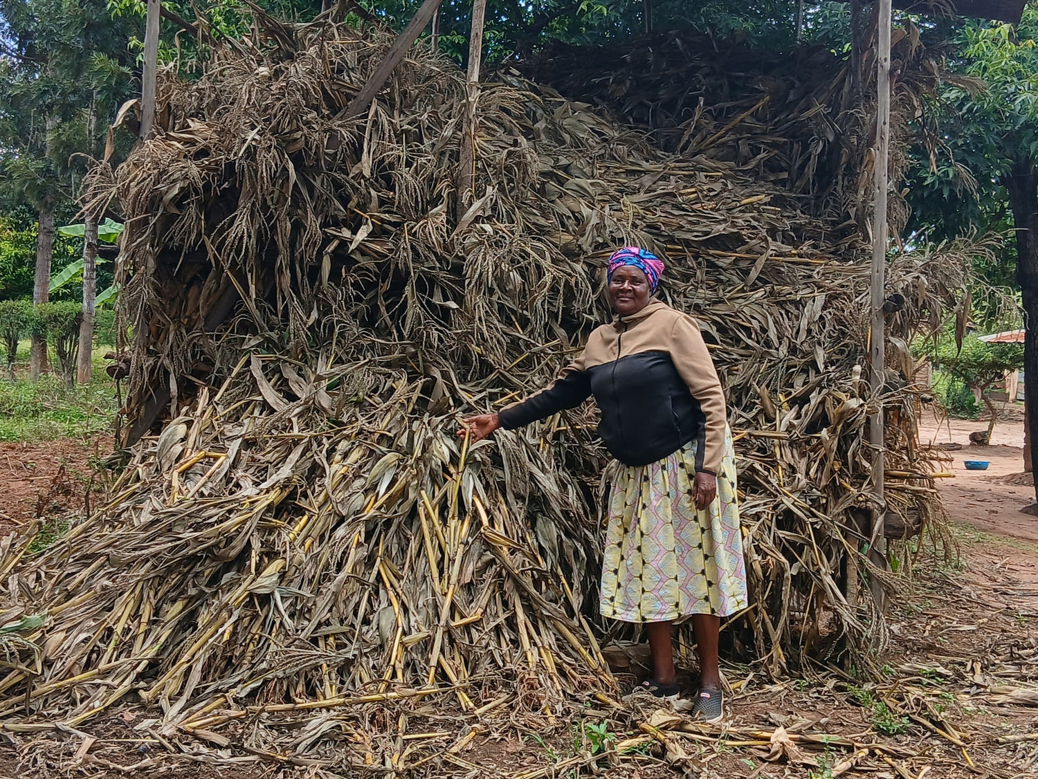 Alice standing next to her successful pile of harvest 
