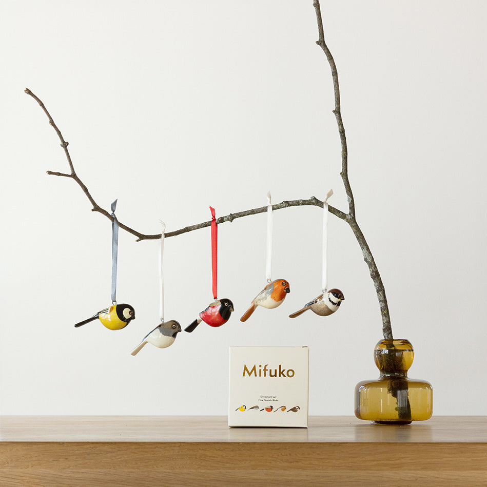 finnish bird ornaments in a branch, handmade fair trade