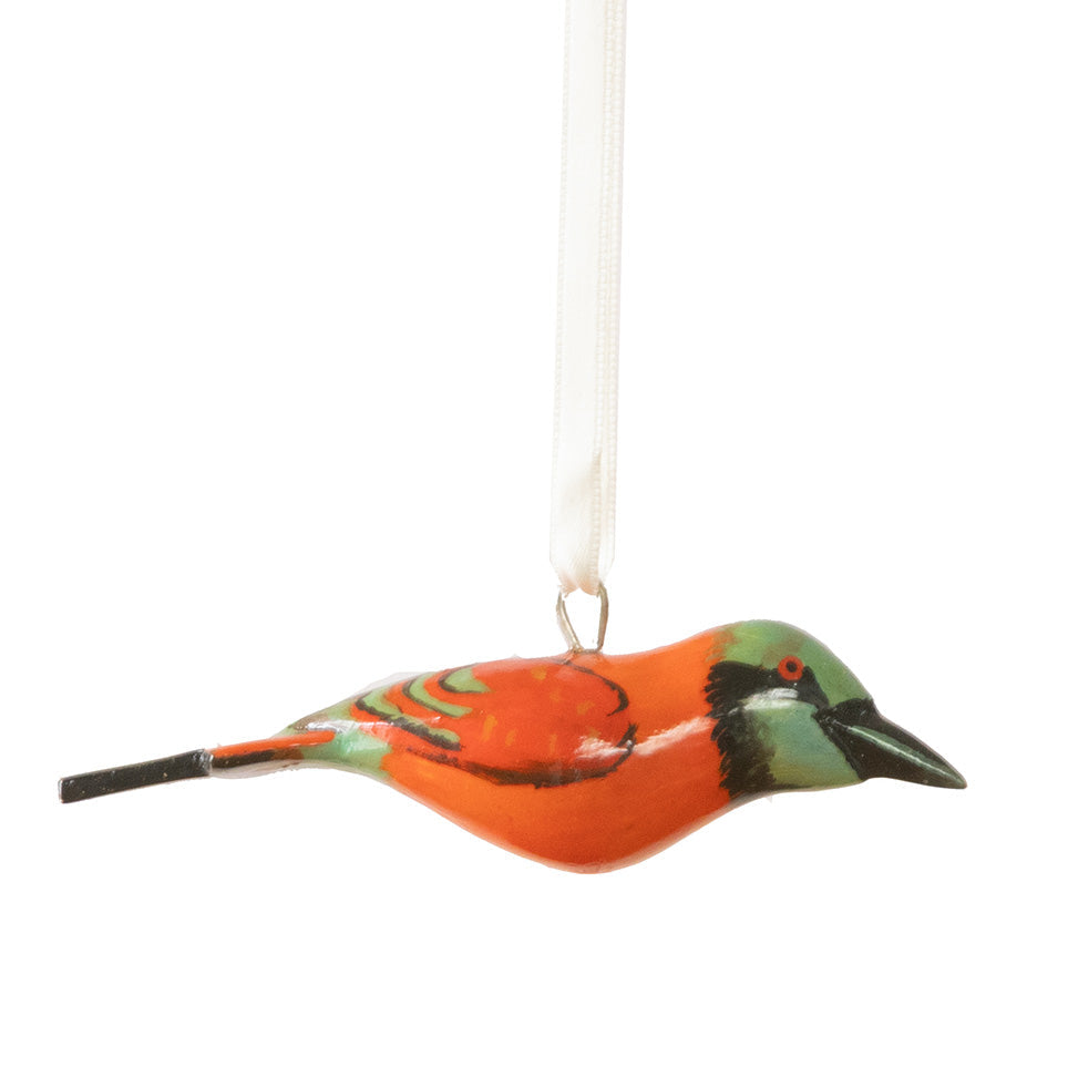 Decorative bird ornament with orange and green colors on a white background