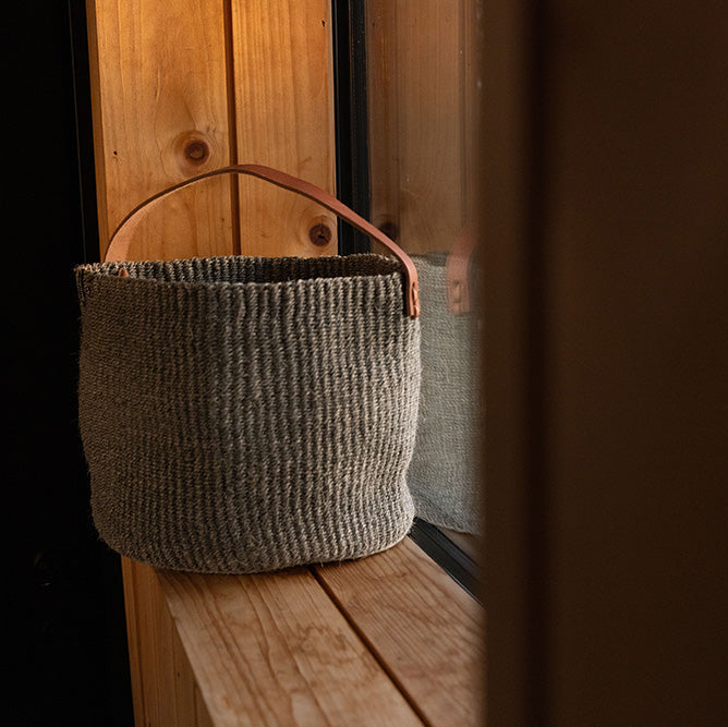 Woven basket on a wooden surface with a blurred background