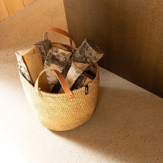 Woven basket with books and papers on a textured surface