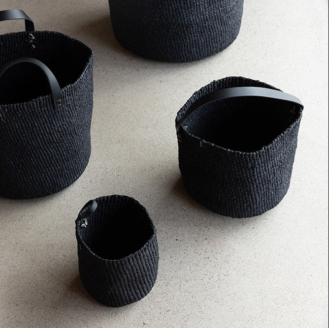 Black woven baskets on the floor 