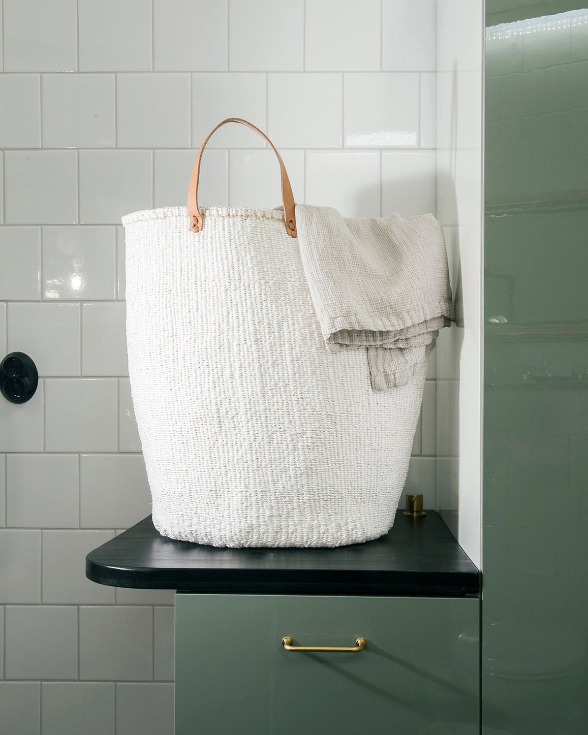 Beautiful white laundry basket with towel, handmade fair trade