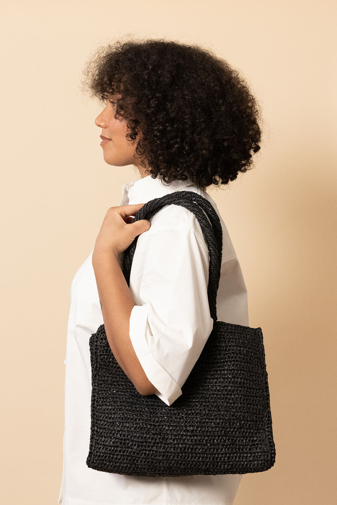 girl with black crocheted tote bag