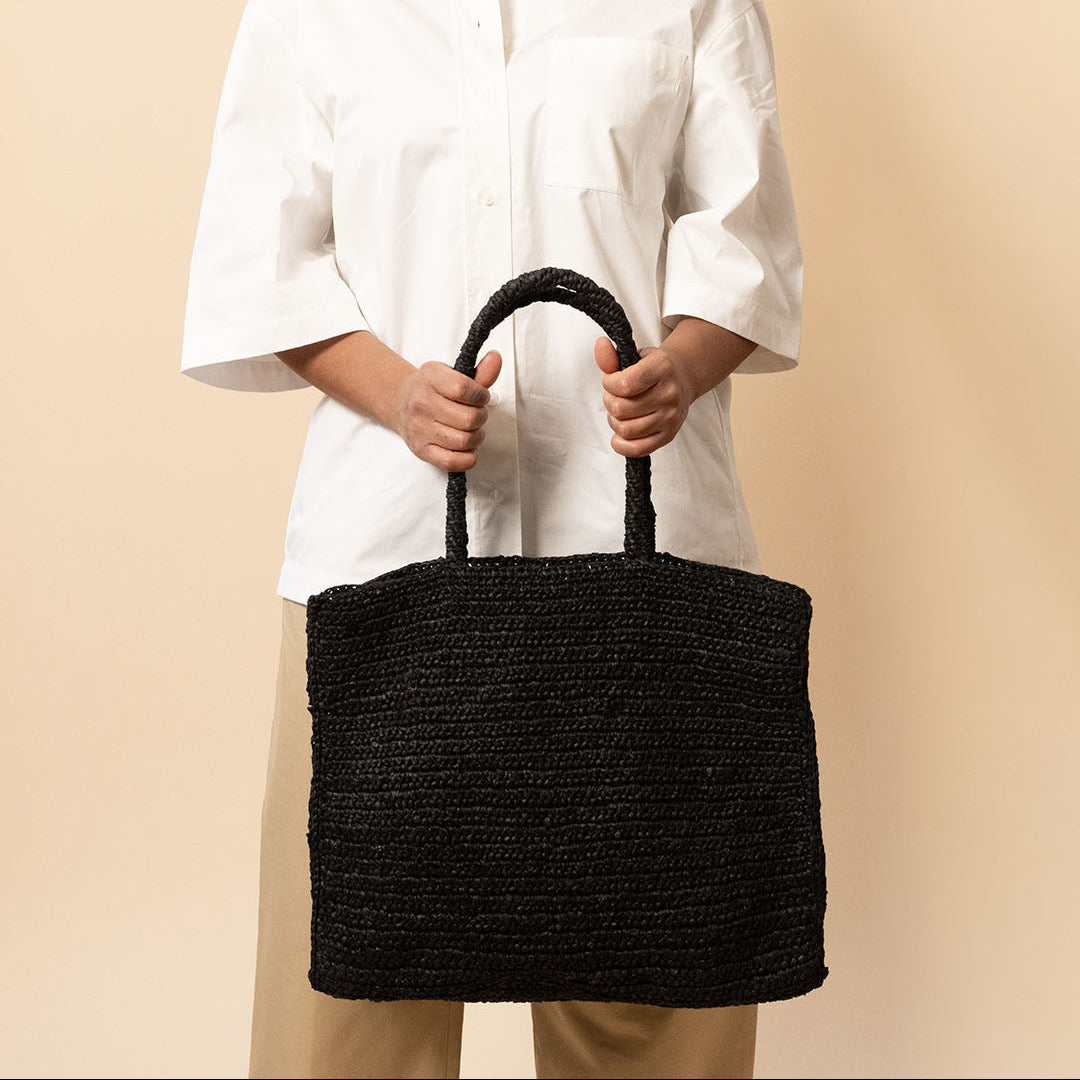 girl with black crocheted tote bag