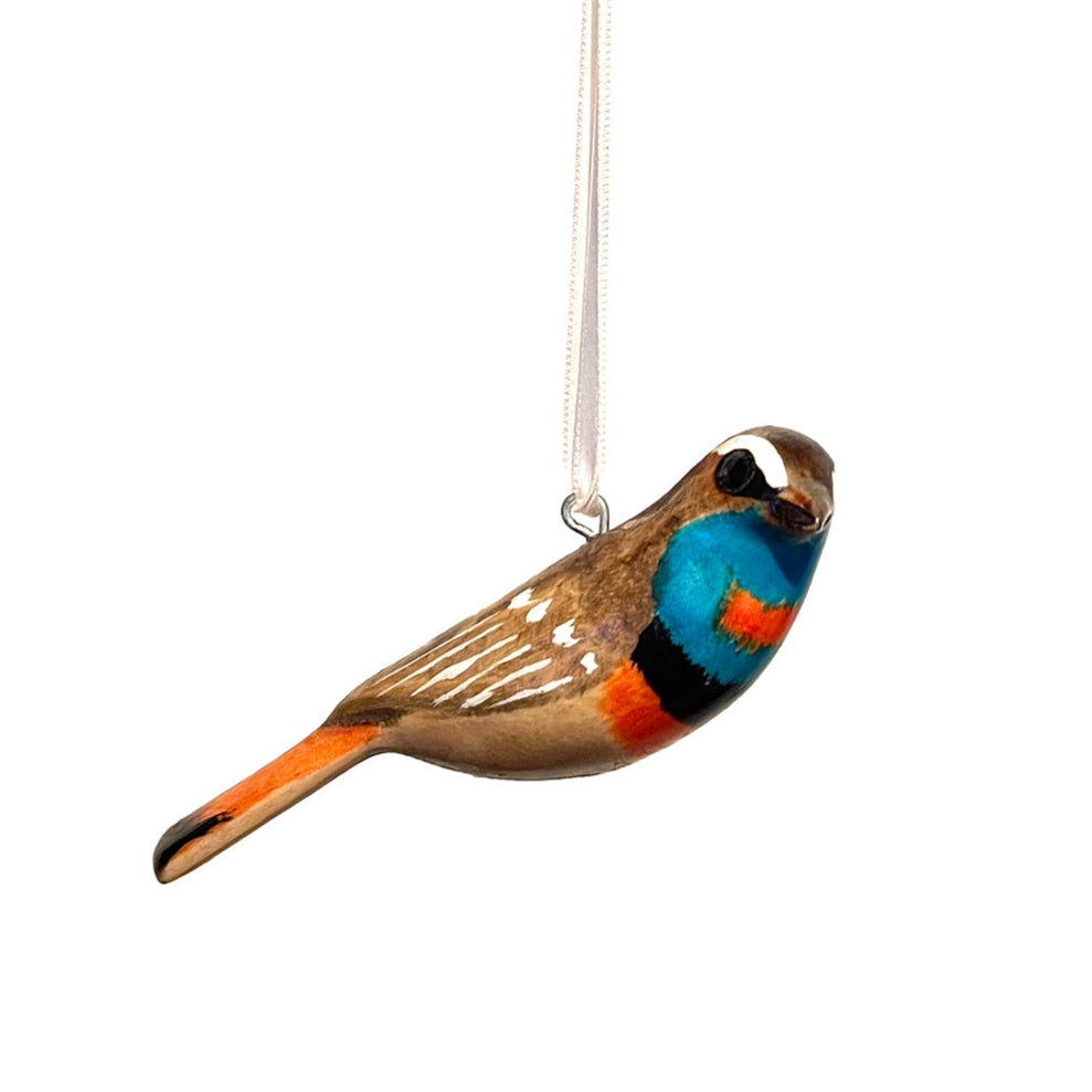 The Nightingale of Lapland ornament is a stunning tribute to the beauty of nature and traditional craftsmanship. Carefully handcrafted by skilled artisans in Nairobi, Kenya, this ornament is made from sustainable wood, combining timeless artistry with environmental responsibility.